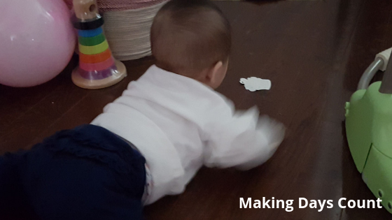 Baby K playing with a bookmark 